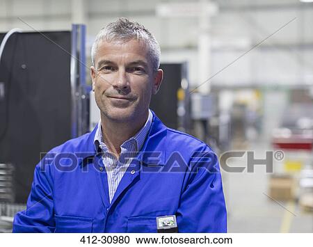 Portrait smiling worker in steel factory View Large Photo Image Stock Image - Portrait smiling worker in steel factory. Fotosearch