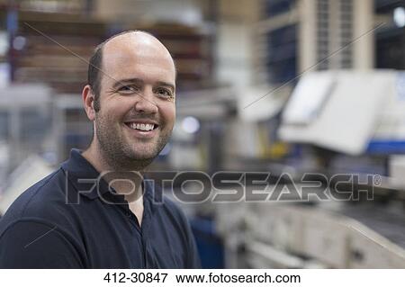 Stock Photo - Portrait smiling worker in steel factory. Fotosearch