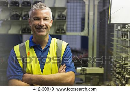 Portrait smiling worker in steel factory View Large Photo Image Stock Photo - Portrait smiling worker in steel factory. Fotosearch