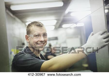 Stock Photo - Portrait smiling worker in steel factory. Fotosearch