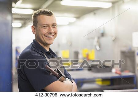 Portrait smiling worker in steel factory View Large Photo Image Stock Photograph - Portrait smiling worker in steel factory. Fotosearch