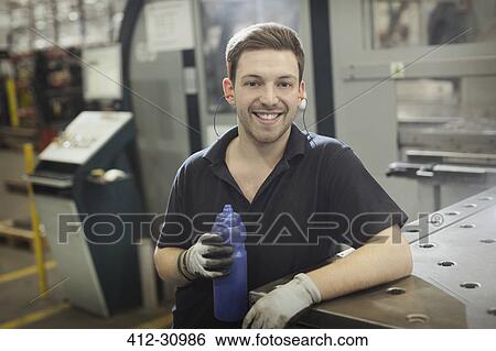 Portrait smiling worker with water bottle in steel factory View Large Photo Image Stock Photograph - Portrait smiling worker with water bottle in steel factory. Fotosearch