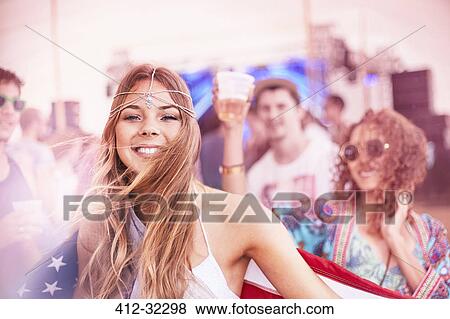 Portrait smiling young woman with American flag at music festival View Large Photo Image Stock Photo - Portrait smiling young woman with American flag at music festival. Fotosearch