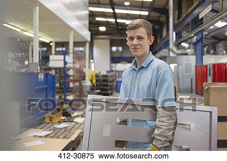 Portrait worker carrying piece in steel factory View Large Photo Image Stock Photography - Portrait worker carrying piece in steel factory. Fotosearch