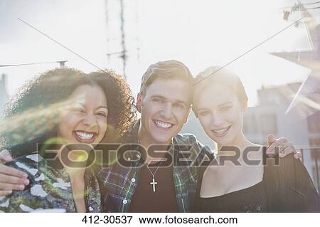 Portrait young adult friends smiling outside View Large Photo Image Stock Photo - Portrait young adult friends smiling outside. Fotosearch