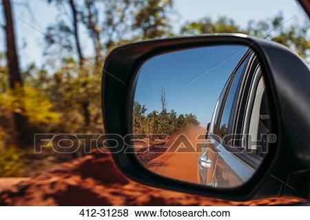Red clay dust cloud in side-view mirror of car View Large Photo Image Stock Photo - Red clay dust cloud in side-view mirror of car. Fotosearch