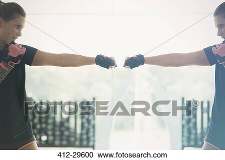 Reflection of woman shadow boxing at gym studio mirror View Large Photo Image Stock Image - Reflection of woman shadow boxing at gym studio mirror. Fotosearch