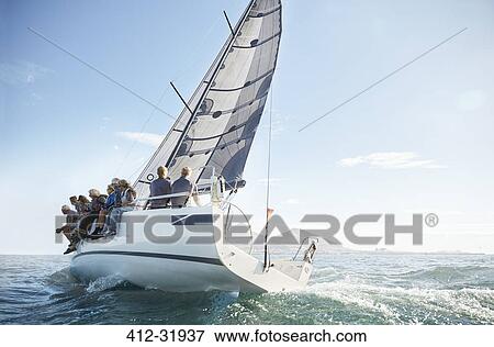 Retired friends on sailboat under blue sky View Large Photo Image Stock Photo - Retired friends on sailboat under blue sky. Fotosearch