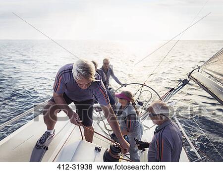 Stock Photo - Retired friends sailing on sunny ocean. Fotosearch