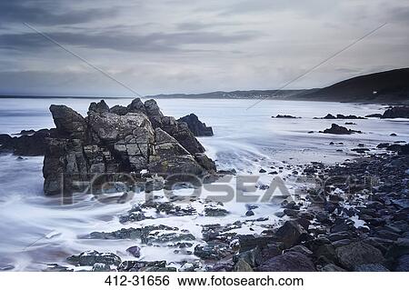 Stock Photograph - Rocks and ocean, Devon, United Kingdom. Fotosearch