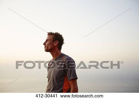 Runner taking a break and looking at ocean view View Large Photo Image Stock Image - Runner taking a break and looking at ocean view. Fotosearch