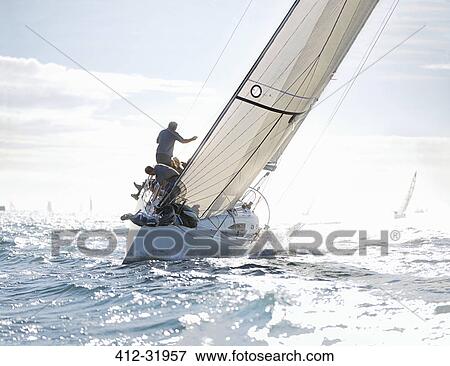 Sailboat heeling on sunny ocean View Large Photo Image Stock Photo - Sailboat heeling on sunny ocean. Fotosearch