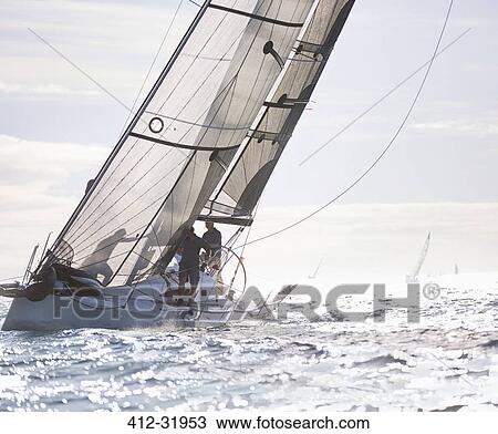 Stock Image - Sailboat on sunny ocean. Fotosearch