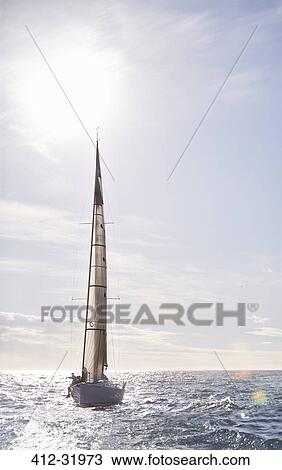 Sailboat on sunny ocean View Large Photo Image Stock Image - Sailboat on sunny ocean. Fotosearch