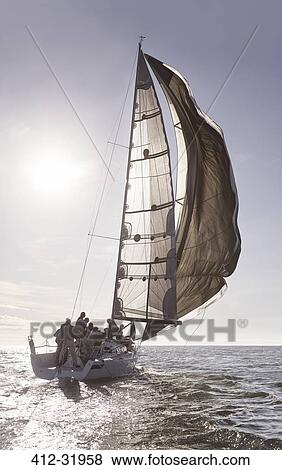 Stock Photo - Sailboat on sunny ocean. Fotosearch