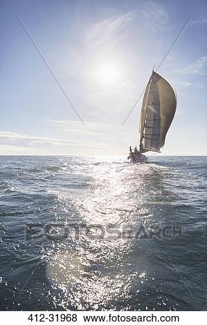 Sailboat on sunny ocean View Large Photo Image Stock Photo - Sailboat on sunny ocean. Fotosearch