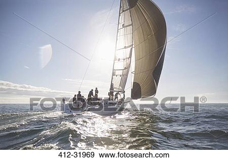 Stock Photo - Sailboat on sunny ocean. Fotosearch