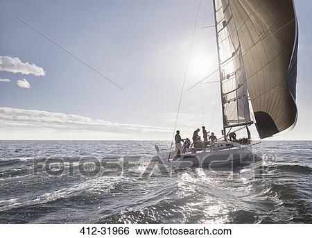 Stock Photograph - Sailboat on sunny ocean. Fotosearch