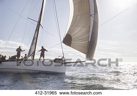 Stock Photography - Sailboat on sunny ocean. Fotosearch