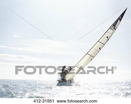 Sailboat tilting on sunny ocean View Large Photo Image Stock Image - Sailboat tilting on sunny ocean. Fotosearch