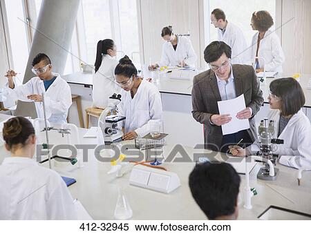 Stock Photography - Science professor and college students using microscopes in science laboratory classroom. Fotosearch