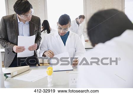 Science professor helping college student in science laboratory classroom View Large Photo Image Stock Photo - Science professor helping college student in science laboratory classroom. Fotosearch