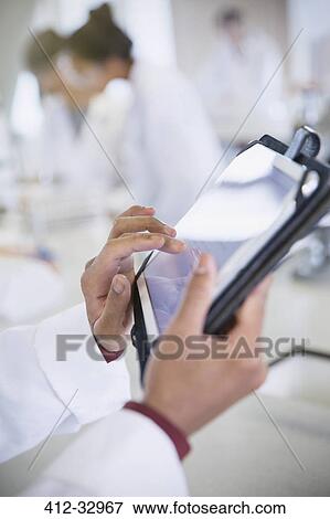 Scientist using digital tablet in laboratory View Large Photo Image Stock Photo - Scientist using digital tablet in laboratory. Fotosearch