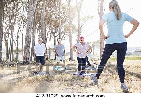 Senior adults practicing yoga in sunny park View Large Photo Image Stock Photo - Senior adults practicing yoga in sunny park. Fotosearch