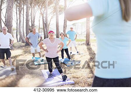 Senior adults practicing yoga in sunny park View Large Photo Image Stock Photography - Senior adults practicing yoga in sunny park. Fotosearch