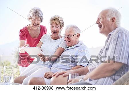 Senior adults using digital tablet View Large Photo Image Stock Photo - Senior adults using digital tablet. Fotosearch