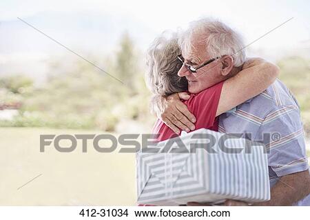 Senior couple hugging and celebrating birthday View Large Photo Image Picture - Senior couple hugging and celebrating birthday. Fotosearch