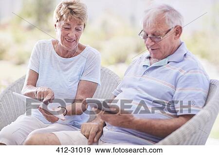 Senior couple using digital tablet View Large Photo Image Stock Photo - Senior couple using digital tablet. Fotosearch