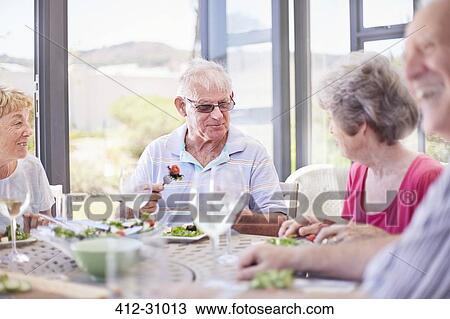 Senior couples enjoying patio lunch View Large Photo Image Stock Image - Senior couples enjoying patio lunch. Fotosearch