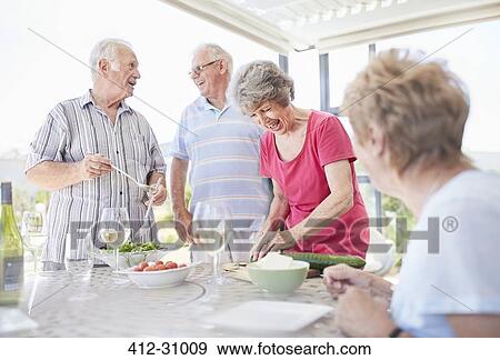 Senior couples preparing patio lunch View Large Photo Image Stock Photo - Senior couples preparing patio lunch. Fotosearch