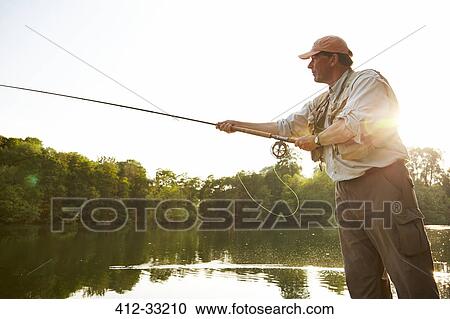 Senior man fly fishing at summer lake View Large Photo Image Stock Image - Senior man fly fishing at summer lake. Fotosearch