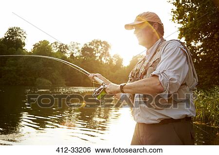 Senior man fly fishing at summer lake View Large Photo Image Stock Photograph - Senior man fly fishing at summer lake. Fotosearch