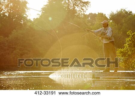 Senior man fly fishing at sunny summer lake View Large Photo Image Stock Image - Senior man fly fishing at sunny summer lake. Fotosearch