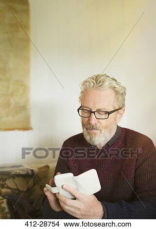 Senior man texting on cell phone View Large Photo Image Picture - Senior man texting on cell phone. Fotosearch