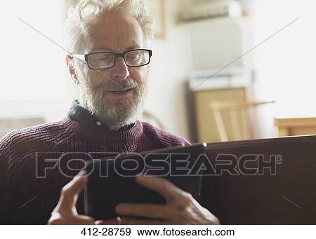 Senior man with eyeglasses using digital tablet View Large Photo Image Stock Photo - Senior man with eyeglasses using digital tablet. Fotosearch