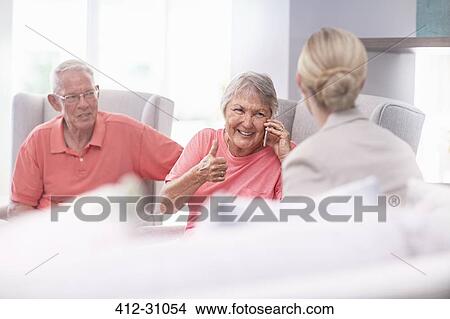 Senior woman talking on cell phone gesturing thumbs up View Large Photo Image Picture - Senior woman talking on cell phone gesturing thumbs up. Fotosearch