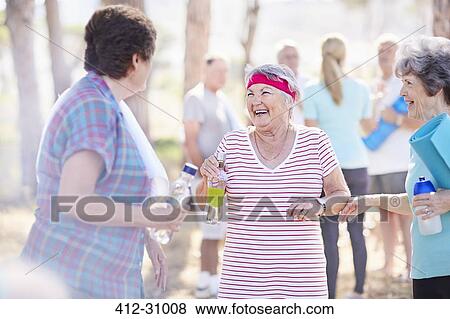 Senior women talking after yoga class in park View Large Photo Image Stock Photo - Senior women talking after yoga class in park. Fotosearch