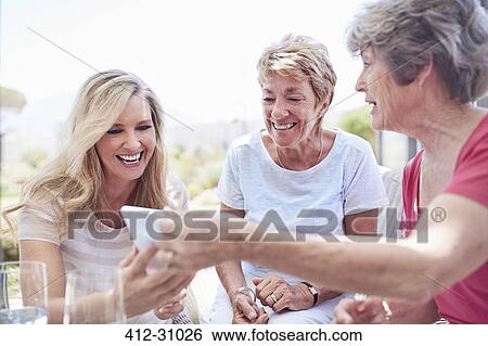 Senior women using cell phone View Large Photo Image Stock Photograph - Senior women using cell phone. Fotosearch