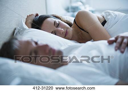 Serene couple sleeping in bed View Large Photo Image Stock Image - Serene couple sleeping in bed. Fotosearch