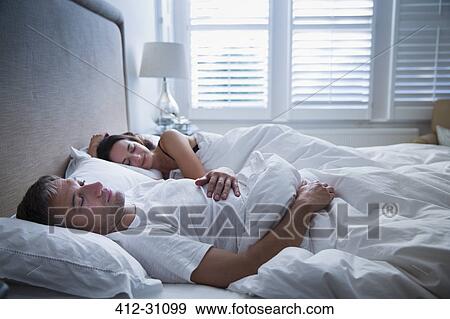 Serene couple sleeping in bed View Large Photo Image Stock Photo - Serene couple sleeping in bed. Fotosearch