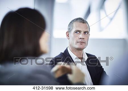 Serious businessman in meeting View Large Photo Image Stock Photo - Serious businessman in meeting. Fotosearch