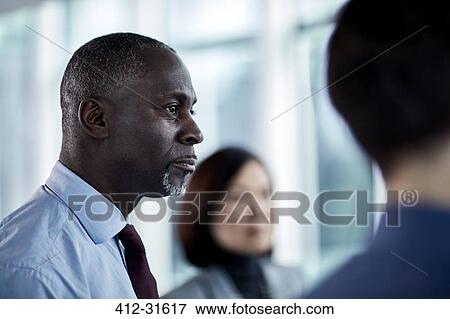 Serious businessman looking away View Large Photo Image Stock Photo - Serious businessman looking away. Fotosearch