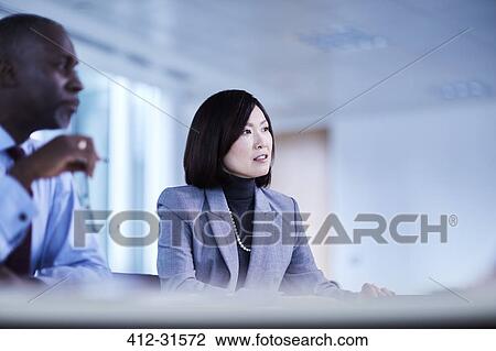 Stock Image - Serious businesswoman in meeting. Fotosearch