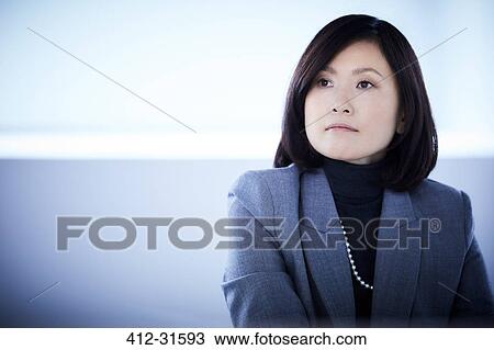 Stock Image - Serious businesswoman looking away. Fotosearch