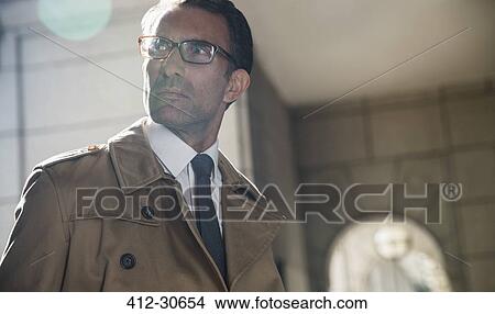 Serious corporate businessman looking away View Large Photo Image Picture - Serious corporate businessman looking away. Fotosearch