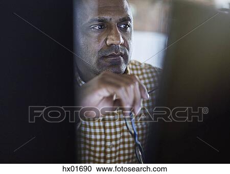Serious focused businessman working at computer View Large Photo Image Stock Image - Serious focused businessman working at computer. Fotosearch